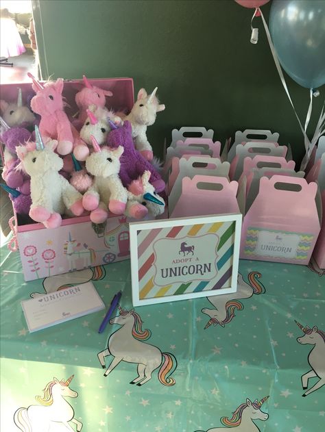 Unicorn party  Plush unicorns in a chest  from Burlington coat factory, table boxes from Amazon, adoption certificates box stickers and digital sign file from homespun hostess on Etsy white frame from wal mart, and target tablecloth Adopt A Unicorn, Rainbow Unicorn Birthday Party, Unicorn Birthday Party Decorations, Rainbow Unicorn Party, Burlington Coat Factory, Unicorn Themed Birthday Party, Digital Sign, Rainbow Unicorn Birthday, Wal Mart