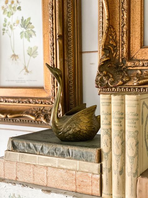 Looking for ways to refresh your mantel with a vintage look? Check out my tips to decorate a mantel using some of my favorite vintage finds! #robynsfrenchnest #springdecor #antiques #frenchfarmhousedecor Decorative Crates, Brass Candle Sticks, Family Room Wall Decor, Empty Picture Frames, Vintage Brass Decor, Brass Swan, Vintage Vignettes, French Farmhouse Decor, Church Pew