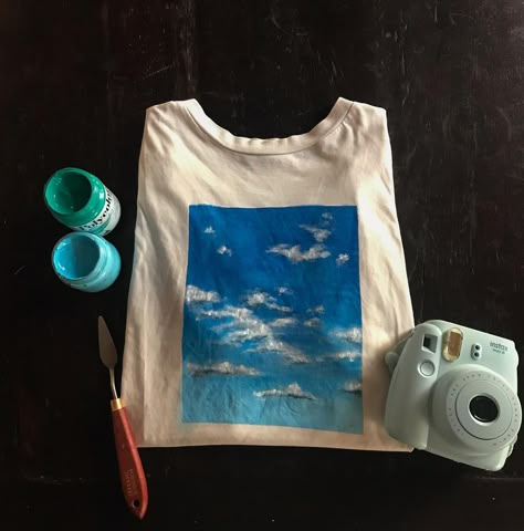 Giulietta-Tenné on Instagram: “Head in the clouds ☁️ Hand painted T-shirt! I love blue sky so I tried to catch it for you! Do you like it? Acrylic on T-shirt 💙” Acrylic Paint On T Shirt, Acrylic Painting On T Shirts, Paint On Tshirt Acrylic, Tshirt Painting Ideas Acrylics, Painting On Clothes T Shirts, Gf Activities, Painting Shirt Ideas, T Shirt Painting Ideas Acrylics, Marauders Birthday