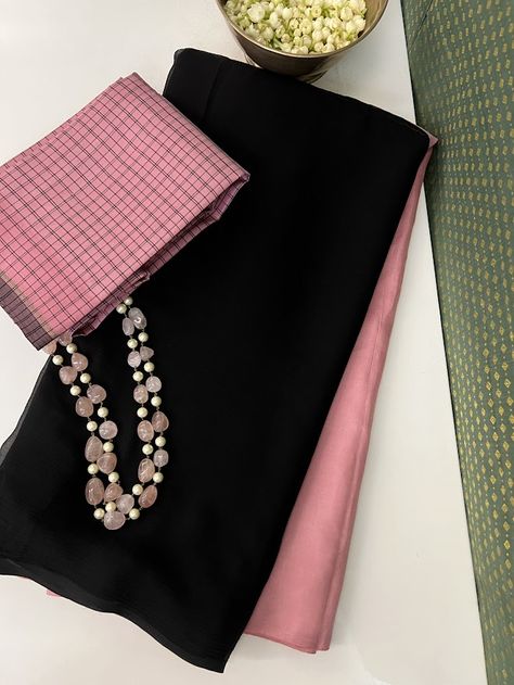 A signature Aavaranaa range, where we have different textures and fabrics in a fusion range. Black chiffon and dusty pink kanchipuram silk in a half and half colour blocked fashion with a solid silk pallu. It comes with a pink black checked silk blouse piece. This is a range that can easily last a long day at work and still look fresh for an evening with friends Black Combination Color Dress, Fusion Saree, Saree Combination, Saree Color Combinations, New Sarees, Saree Styling, Evening With Friends, Colour Blocking Fashion, Blouse Designs Catalogue