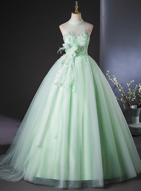 Eighteen layers of elegance come together in this enchanting mint-green Quinceanera dress! The halter neckline brings a contemporary edge, while the soft tulle layers create a flowing, graceful look perfect for making a dramatic entrance. Delicate floral appliques are intricately placed across the bodice, adding texture and dimension to the gown, while the subtle sheen of the fabric gives it a luminous quality under the lights. The dress captures the spirit of a Quinceanera celebration, full of youthful energy and timeless beauty.  Designed for movement, the lightweight tulle and satin layers make it easy to glide across the dance floor, ensuring that every twirl is picture-perfect. The fitted waistline flatters the figure, while the ballgown skirt adds the drama expected from such a grand Butterfly Ball Gown, Mint Green Quinceanera Dresses, Mint Prom Dress, Quinceanera Dresses Green, Green Quinceanera Dresses, Flower Prom Dress, A Line Prom Dress, Halter Prom Dresses, Green Tulle