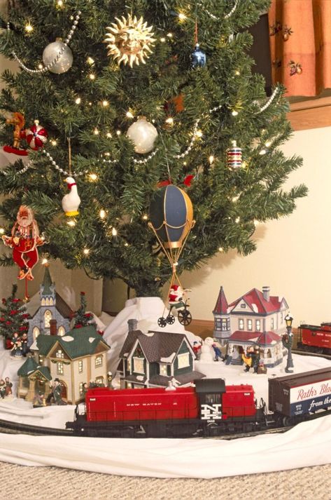 Choosing a train for the Christmas tree | News, Sports, Jobs - Lawrence Journal-World: news, information, headlines and events in Lawrence, Kansas Christmas Tree With Train And Village, Train Under Christmas Tree, Train Around Christmas Tree, Christmas Tree Train Set, Christmas Trains, Christmas Tree Train, Christmas Train Set, Christmas Layout, Christmas Tree Village