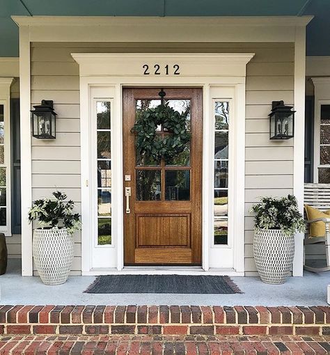 Haven’t worked on the front porch since December but when it’s March and 60 degrees...you get to it! Spring, we’re ready for you! Front Door With Lanterns, Decorate With Shutters Inside, Traditional Home Front Door, Front Door Tudor Home, Front Door With Shutters On Each Side, Front Door For Brown House, Wood Front Door Brick House, Wood Front Door White House, Farmhouse Style Front Door