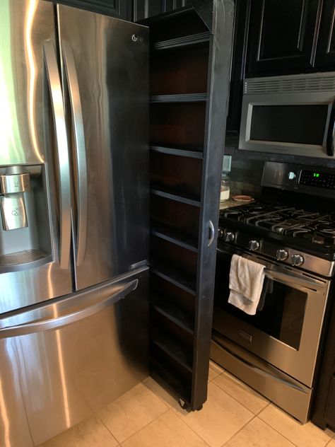 Custom rolling spice rack between cabinet and fridge. Sliding Spice Rack Cabinet Next To Fridge, Side Fridge Spice Rack, Custom Spice Rack, Tall Pull Out Spice Rack Cabinet, Rolling Spice Rack By Fridge, Spice Rack Next To Oven, Kitchen Cabinet Roll Out Shelves, Pull Out Spice Rack Next To Fridge, Bbq Storage Ideas