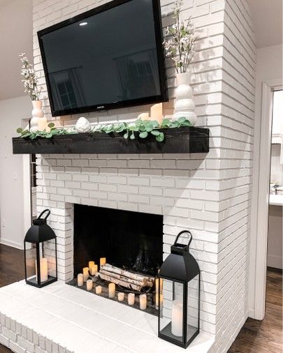 Living room farmhouse home decor  White fireplace Black lanterns  Remote control amazon candles Eucalyptus garland Spring home decor    http://liketk.it/2BWSl #liketkit @liketoknow.it #LTKunder50 #LTKunder100 #LTKstyletip #LTKspring #LTKsalealert #LTKhome #LTKfamily Neutral Farmhouse Living Room, Living Room Decor White, Modern Farmhouse Fireplace, Room Decor White, White Brick Fireplace, Spring Home Decor Ideas, Andong, Neutral Farmhouse, Brick Fireplace Makeover