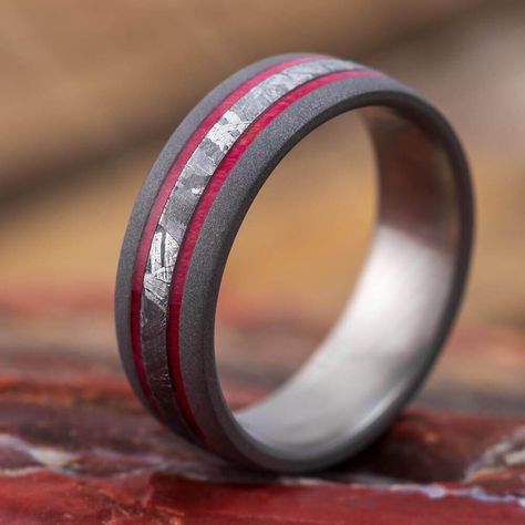 This men's wedding band frames Gibeon meteorite in red box elder burl wood. The red color of the wood pairs well with the pattern of the meteorite in this unique wedding band.The wood in this wedding band includes FREE Ring Armor Waterproofing (a $75 value).*This ring can only be made in titanium.RING LAYOUT - Men's Wedding Band with Meteorite and Red Box Elder Burl Wood-4152 Ring Width: 7 mm Ring Sleeve: Titanium Ring Profile: Round Ring Finish: Sandblasted*1.5 mm Sandblasted Titanium 1 mm Red Men Engagement Rings, Meteorite Rings, Ring Armor, Wedding Bands For Men, Gibeon Meteorite, Meteorite Jewelry, Box Elder, Unique Wedding Band, Black Wedding Rings