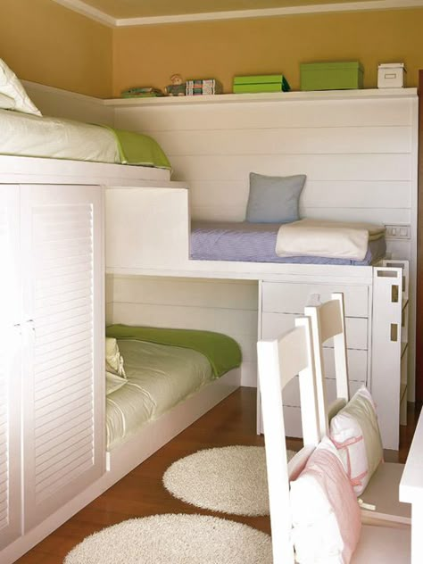 How do you fit three beds, a desk and two chairs into a typical sized bedroom? And did we mention adding a closet too? You make custom bunks that give each child their own little hideaway without feeling like they're being shoved in a corner. I love this!!! Going to need it very soon. Triple Bunk Bed, Triple Bunk, Small Space Bedroom, Kids Bunk Beds, Guest Bed, Small Room, Bunk Bed, Small Space Living, Kids' Room