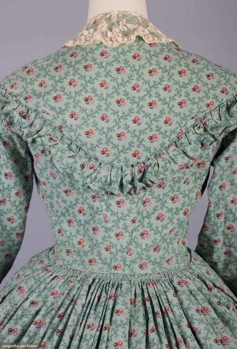 Day Dress, dated from the 1850's. Finely crafted of wool, this darling dress features a printed berry cluster motif, a tambour embroidered net collar, needlework buttons, a full skirt with double box pleating in front and cartridge pleating in back, and box pleated ruffles. Source: Augusta Auctions Box Pleated Dress, Cartridge Pleats, 1860s Dresses, Augusta Auctions, 19th Century Clothing, Green Ground, Historical Dress, Historic Clothing, Century Clothing