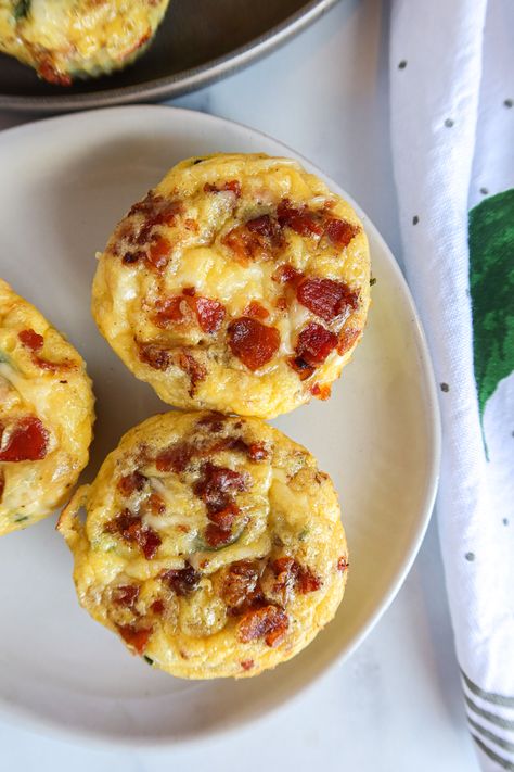 This is the best, healthy, quick & easy leftover Easter ham recipe. Get out your muffin tin! These mini, no crust quiche cups with goat cheese, cheddar cheese, spinach, red onion & bacon bits are SO good. They're also keto-friendly, low carb & gluten free. They come together in just 30-40 minutes for a tasty breakfast the whole family will love. Freeze or refrigerate your cups for a make ahead breakfast you can enjoy all week. If you like Starbucks egg bites you'll adore these mini quiche ... Ham And Cheese Quiche Muffins, Muffin Quiche Recipes Crustless, Mini Quiches In Muffin Tin Gluten Free, Crustless Quiche In Muffin Tins, Gluten Free Mini Quiche Recipes, Freezable Mini Quiche, Quiche Muffin Tin, Muffin Tin Quiche Recipes, Gluten Free Egg Muffin Cups