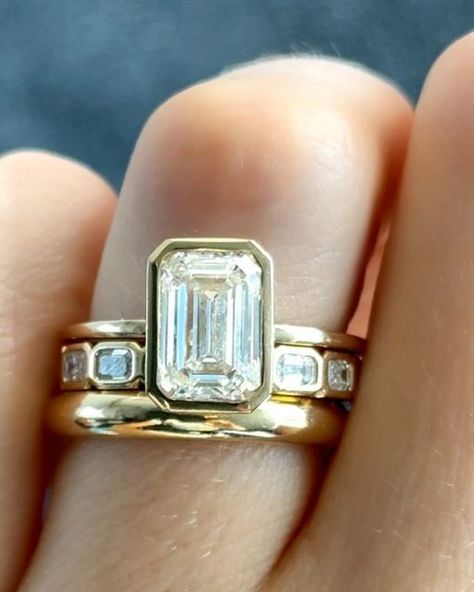 GOODSTONE on Instagram: "Our beloved Penumbra Bezel Set Engagement Ring💍 with an Emerald Cut seen two ways in: Yellow Gold and Blackened Rhodium. ✨Which style would you wear? Share this with someone who would love these rings💕  #engagementring #engagementrings #emeraldcutdiamond #emeraldcutdiamonds #emeraldring #bezelsetting #goodstone" Bezel Emerald Engagement Ring With Wedding Band, Bezel Wedding Ring Stack, Wedding Bands With Bezel Engagement Ring, Emerald Bezel Engagement Ring Stack, Bezel Set Engagement Ring Stack, Emerald Engagement Ring Bezel Set, Bezel Set Ring Stack, Bezel Emerald Engagement Ring Stack, Emerald Bezel Engagement Ring With Band