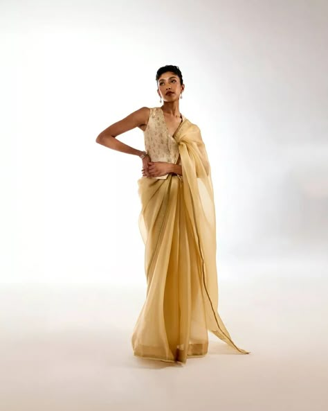 Old-world grandeur, combined with modern-day effortlessness. The light gold Triveni saree perfectly complements our delicately rose-patterned meenakari brocade blouse, crafted in a contemporary waistcoat style silhouette. Jewelry courtesy: @thehouseofrose #Tilfi #TilfiSarees #TilfiIcons Glamorous Semi-stitched Saree With Traditional Drape, Saree Drapes Modern, Gold Traditional Drape Saree For Diwali, Transitional Designer Wear Gold Pre-draped Saree, Artistic Saree With Traditional Drape, Saree Draping Styles Modern, Grad Picture Ideas, Brocade Blouses, Saree Trends