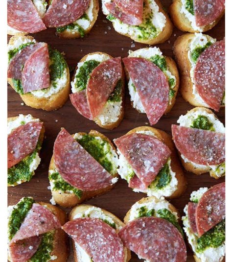 Salami, Pesto, and Ricotta Crostini Serves 12  Slice 1 large baguette on the bias to get 24 pieces. Put the baguette slices on a rimmed baking sheet. Brush both sides of the bread with 3 Tbsp. olive oil and then season with salt and pepper. Bake at 425º F until the bread is golden brown and crisp (but still a little soft on the inside), 8 to 10 minutes. Now you have ~crostini~.  Spread 1 cup ricotta on the crostini, then top with ½ cup pesto, and 4 oz. thinly sliced salami, dividing all ingr... Baguette Appetizer, Salami Appetizer, 7 Course Meal, Ricotta Crostini, Baguette Slices, Healthy Pesto, Crostini Appetizers, Baguette Recipe, Sliced Salami