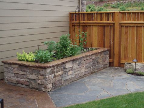 Raise vegetable bed with cultured stone side walls and fitted iron mt stone pathway. Stone Planter Boxes, Stone Garden Wall, Tall Planter Boxes, Stone Flower Beds, Brick Planter, Diy Patio Pavers, Stone Planter, Garden Walls, Diy Planter Box