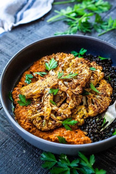 Roasted Cauliflower Steaks with Romesco Sauce over a bed of simply seasoned lentils. A simple, easy vegan dinner made on a sheet pan! Fine Dining Date, Seasoned Lentils, Fancy Vegetarian Dinner, Plant Based Dinner Recipes, Cauliflower Steaks Recipes, Bright Line Eating Recipes, Roasted Cauliflower Steaks, French Green Lentils, Feasting At Home