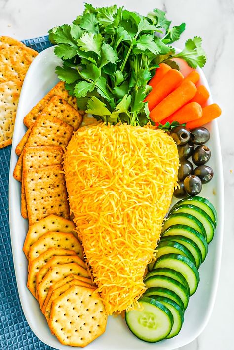 This playful Easter cheese ball is made with just 6 ingredients including cream cheese, cheddar, bacon, ranch seasoning mix, and Worcestershire sauce. Formed into the shape of a carrot, sprinkled with cheese, and finished off with fresh leafy greens for the carrot top, this adorable appetizer is colorful, fun, and delicious with crackers! Easter Cheese Ball Recipes, Carrot Cheese Ball, Easter Cheese Ball, Cracker Spreads, Easter Apps, Easter Cheese, September Flower, Sweet Appetizer, Easter Party Food