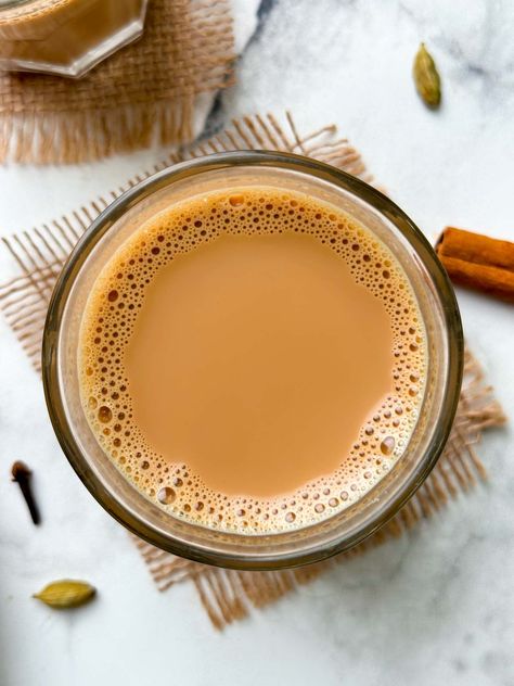 indian masala chai served in a glass cup with whole spices on the side Indian Chai Tea Recipe, Masala Chai Tea Recipe, Spiced Milk, Indian Chai Tea, Indian Masala Chai, Masala Chai Recipe, Indian Milk, Masala Chai Tea, Indian Chai