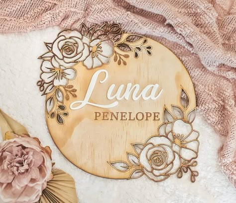 33 Simply Stunning Nursery Name Signs That You Will Adore - Messy Bun Motherhood Floral Name Sign, Baby Shower Announcement, Glowforge Ideas, Floral Signs, Gold Backdrop, Wood Name Sign, Laser Engraved Ideas, Wooden Name Signs, Engraving Ideas