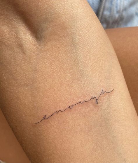 Light Gray Tattoos For Women, Tattoo Ideas Female Self Worth, Minimalist Tattoo For Healing, Cursive Minimalist Tattoo, Cursive Fine Line Tattoo Font, Enough Cursive Tattoo, Tattoo Below Elbow Crease, Tiny Cursive Tattoo, Dainty Word Tattoos For Women