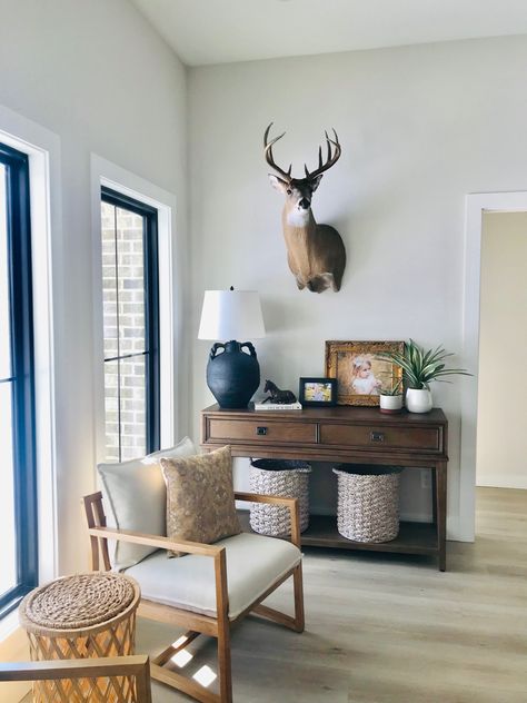 Antlers In Living Room, Deer Head Dining Room, Deer Head Office Decor, Modern Farmhouse Living Room With Deer Mounts, Living Room Wall Decor With Deer Head, Living Room With Taxidermy Wall Decor, Gallery Wall Ideas With Deer Head, Antlers Interior Design, Deer Office Decor