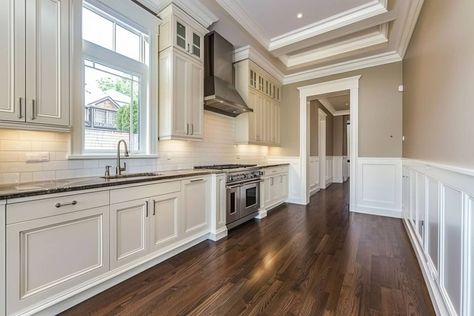 kitchen with white wainscoting and wood floor Kitchen With Waynes Coating, Kitchen Waynes Coating Ideas, Kitchen With Wainscotting, Wainscoting Kitchen Walls, Paneling In Kitchen, Kitchen Wainscoting Ideas, Wainscoting In Kitchen, Kitchen Wainscoting, Waynes Coating