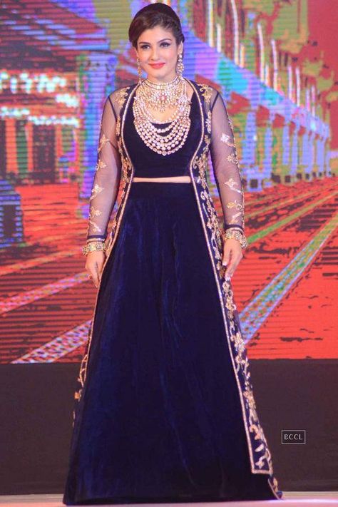 Raveena Tandan in Navy Blue Velvet Lehenga Choli with Long Jacket at IBJA Fashion Show Blue Velvet Lehenga, Gown With Shrug, Bollywood Actress Saree, Andaz Apna Apna, Velvet Lehenga Choli, Navy Blue Gown, Raveena Tandon, Velvet Lehenga, Indian Women Fashion