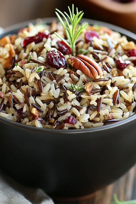 Cranberry Pecan Wild Rice Pilaf is a flavorful dish made with wild rice, cranberries, and pecans. Ideal for special occasions or as a healthy side, this colorful pilaf offers a perfect taste balance. Wild Rice With Cranberries, Baked Wild Rice Recipes, Wild Rice With Cranberries And Pecans, Cranberry Rice Recipes, Cranberry Rice Pilaf, Wild Rice Pilaf With Cranberries, Wild Rice Pilaf Recipe Easy, Rice With Nuts Recipes, Wild Rice Dishes