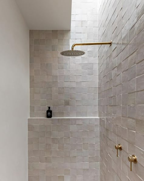 HAAUS.® on Instagram: "Our HAAUS.5 ensuite bathroom is definitely a space you walk into and instantly feel a sense of calm. Zellige tiles paired with brushed brass fixtures = simplicity and elegance in every detail. ✨   The addition of a skylight elevates the ambiance, casting a serene glow over the textures. Who wouldn’t want to shower in here! 😍  Create the Look ~ Wall Tiles: @ambertiles Zellige Ecru Terracotta Moroccan Square Gloss ~ Wall Tile Grout: @ardexaustralia FG8 #248 in Walnut from @ambertiles  ~ Shower Head: @adpaustralia Soul Rain Shower Rose Brushed Brass ~ Shower Arm: @adpaustralia Soul Shower Arm 450mm in Brushed Brass ~ Mixer: @adpaustralia Soul Grove Wall Mixer in Brushed Brass ~ Shampoo: @leifproducts Blue Cypress Shampoo ~ Floor Tiles: @ambertiles Cavestone Sahara 600 Shower Ledge, Shower Wall Tile, Shower Tile Ideas, Space Saving Bathroom, Zellige Tiles, Bathroom Transformation, Shower Rose, Stunning Bathrooms, Zellige Tile