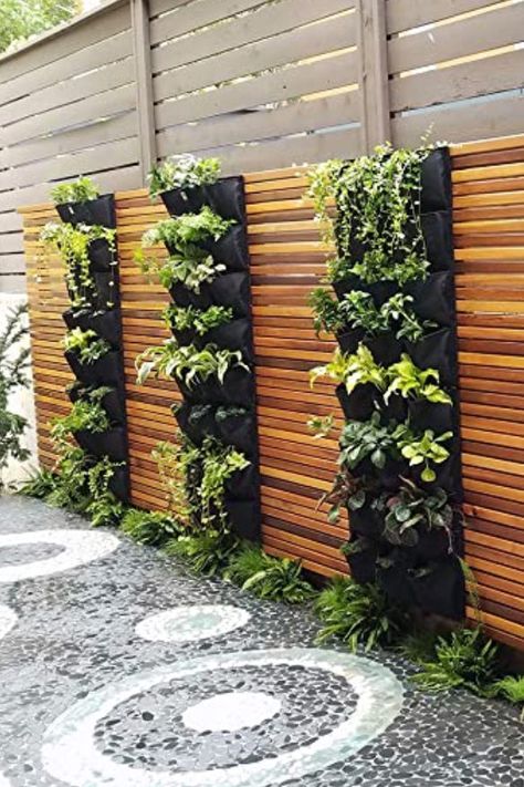 Whether you plant it inside or outside, a vertical garden will give you the space you need to plant flowers, fresh herbs, succulents–you name it—in the tiniest of square footage. From upcycling an old dresser to the simple act of hanging a few pots, one of these DIY vertical garden ideas will surely speak to you. Vertical Garden Wall Planter, Living Wall Planter, Vertical Garden Planters, Vertical Garden Design, Vertical Garden Wall, Vertical Herb Garden, Vertical Planter, Walled Garden, Wall Garden