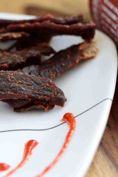 A sriracha beef jerky that doesn't over power you with spice, but rather blends in with the other flavors making a perfect jerky | Jerkyholic.com Teriyaki Jerky Marinade Recipes, Beef Jerkey Marinades, Homemade Teriyaki Beef Jerky, Simple Beef Jerky Recipe, Teriyaki Beef Jerky Recipe, Homemade Beef Jerky Recipe, Jerkey Recipes, Deer Jerky, Jerky Marinade