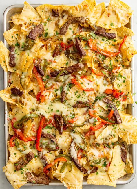 These Philly Cheesesteak Nachos Are Absolutely InsaneDelish Cheesesteak Nachos, Best Philly Cheesesteak, Steak Nachos, How To Make Nachos, Steak Dinner Recipes, Nacho Toppings, Nachos Recipe Easy, Superbowl Appetizers, Fast Foods