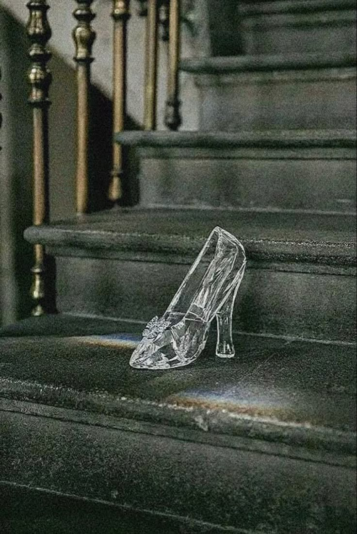 a pair of clear shoes sitting on top of some stairs