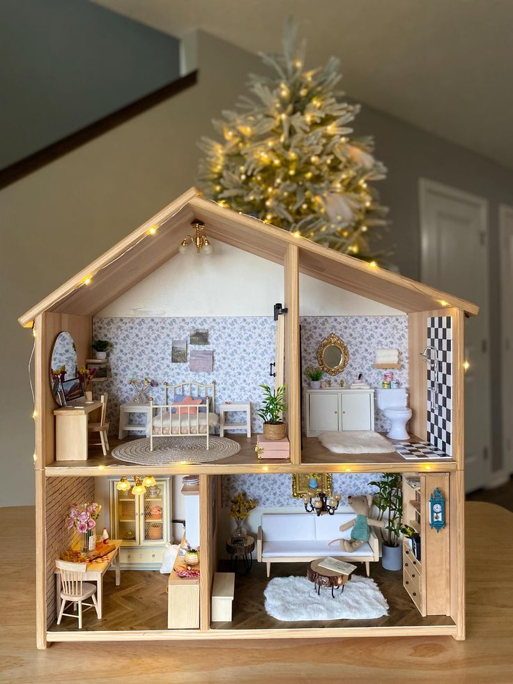 a doll house with lights and furniture inside