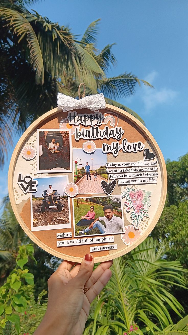 a person holding up a wooden plate with pictures on it