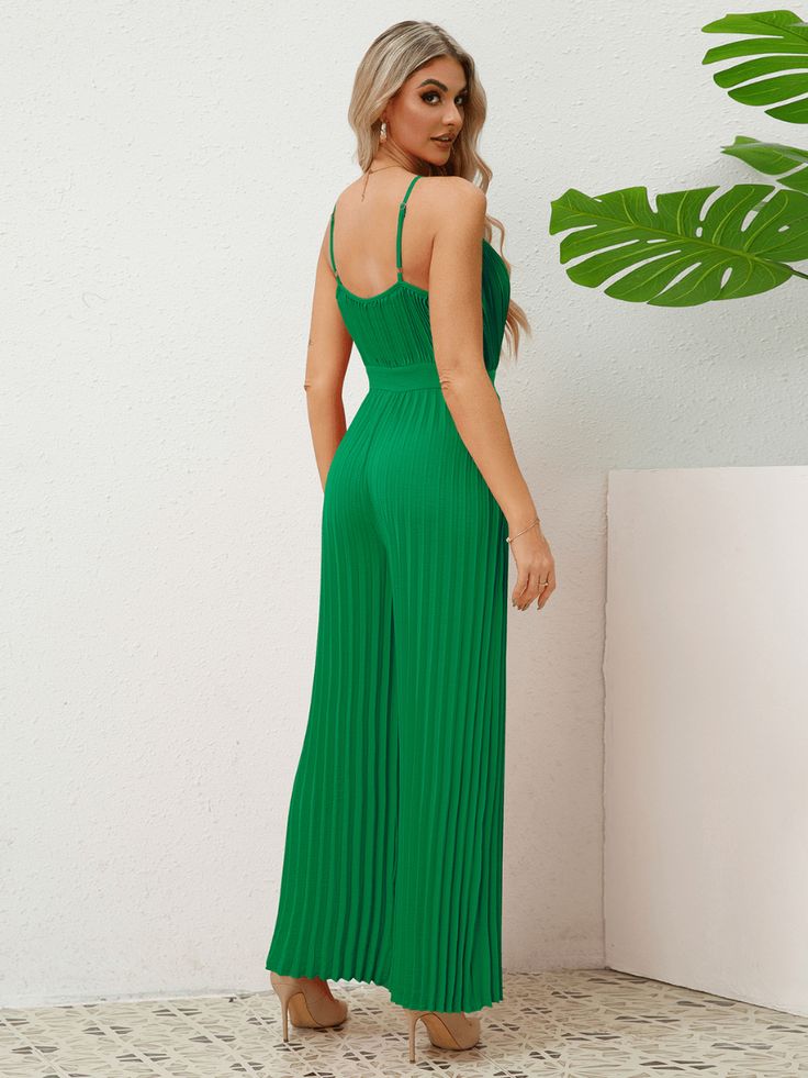 The Felicia Plisse Relaxed Jumpsuit in elegant green is the epitome of luxury and elegance. Crafted with a unique plisse fabric, this jumpsuit drapes effortlessly on the body, creating a relaxed yet sophisticated silhouette. Perfect for any occasion, it exudes exclusivity and refined style. Size Guide: Model is 5’8” tall, and has a 33.2” bust, 26.4” waist, & 35.2” hips. She is wearing a S / US 4 / AU 8. This jumpsuit is true to size. Material: 100% Polyester. Feature: V-Neckline. Adjustable Spaghetti Shoulder Straps. Wide Leg Fit. Plisse Fabrication Details. Relaxed fit. Not Lined. Care Instructions: Machine wash / Cold hand wash Green Sleeveless Jumpsuits And Rompers For Evening, Green Sleeveless Jumpsuits For Evening, Green Summer Evening Jumpsuits And Rompers, Elegant Green Spring Jumpsuits And Rompers, Chic Green Evening Jumpsuits And Rompers, Elegant Pleated Jumpsuits And Rompers For Summer, Sleeveless Pleated Party Jumpsuits And Rompers, Elegant Sleeveless Pleated Jumpsuits And Rompers, Elegant Sleeveless Pleated Jumpsuit And Romper