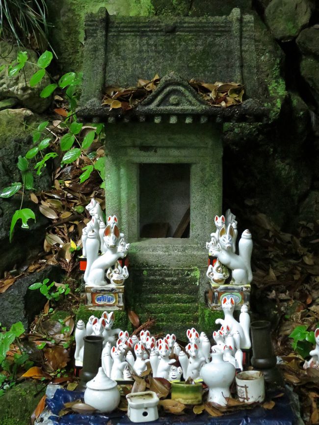 a group of white figurines sitting on top of a table next to a stone wall