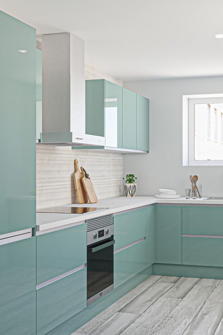 a kitchen with blue cabinets and white counter tops, along with a wooden flooring