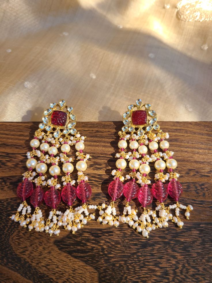 Pure Ahmedabadi pach kundan earrings crafted to perfection! A refined jewelry engraved with precious pachi kundan stones! Each piece has an intricate bead work to enrich its elegance. Size: 3.25 inches Occasion: festival or wedding or casual Metal : copper Stones: pachi kundan Handmade Made in india Care: wipe ur jewelry with soft cloth after each use and store in a airtight plastic bag! Don't soak in water Festive Kundan Jhumkas With Stone Work, Party Kundan Jhumkas In Temple Jewelry Style, Kundan Chandbalis With Gota Work In Temple Style, Kundan Temple Jewelry Jhumkas For Party, Temple Style Kundan Jhumkas For Party, Temple Jewelry Kundan Jhumkas For Party, Festive Temple Jewelry Pearl Earrings With Stone Work, Kundan Jhumkas For Party, Temple Jewelry Style, Party Temple Jewelry Jhumkas With Gota Work