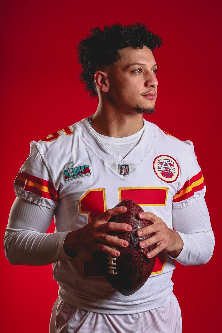 a man holding a football in his hands