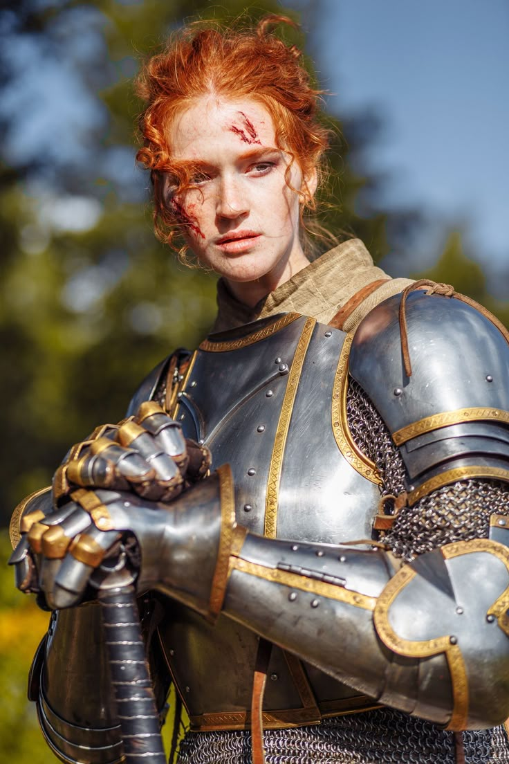 a man dressed in armor with blood on his face