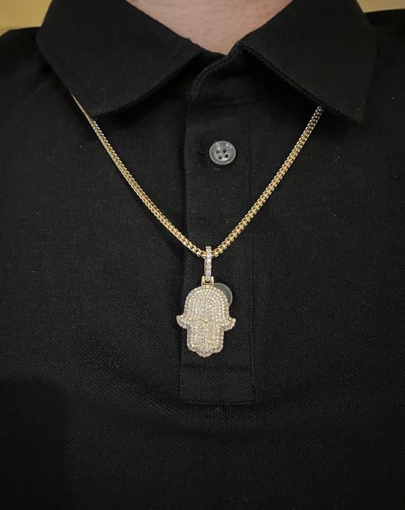 14k solid gold diamond Hamsa Pendant. Material: 14k solid Yellow Gold.Diamonds: 2.50 carats of round brilliant diamonds.Average quality used: VS2-SI1.Average diamond color used: F color.Gold weight: Approximately 9.5 grams.Length: Pendant is Approximately 1 inch long. With diamond bail 1.5 inches long. Width: 0.75 inches wide.Comes with Certificate of authentication.Comes in a nice box.Make it personal. Add a custom engraving to the back of this solid gold pendant. *Chain is sold separately. Mod Hand Set Diamond Pendant Necklaces, Vvs Clarity 14k Gold Diamond Pendant Necklace, Diamond Cuban Link Necklaces For Anniversary, Cuban Link Diamond Necklaces For Anniversaries, Cuban Link Diamond Necklaces For Anniversary, Diamond White Cuban Link Necklace As Gift, Silver Gold-plated Diamond Necklace With Round Pendant, Silver Diamond Cut Necklace Gold Plated, Gold Plated Diamond Necklace In Silver Color