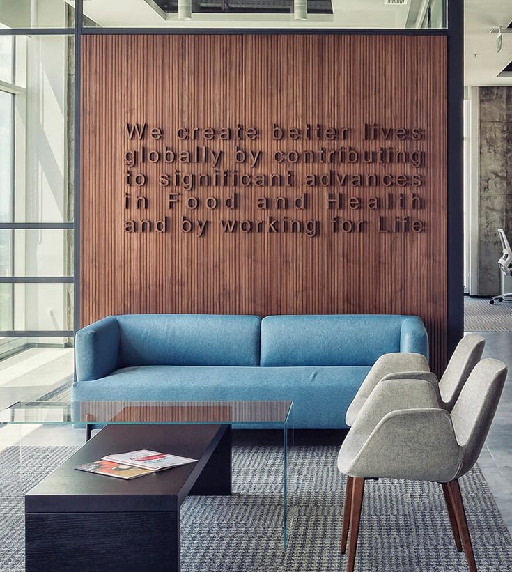 a living room filled with furniture and a quote on the wall