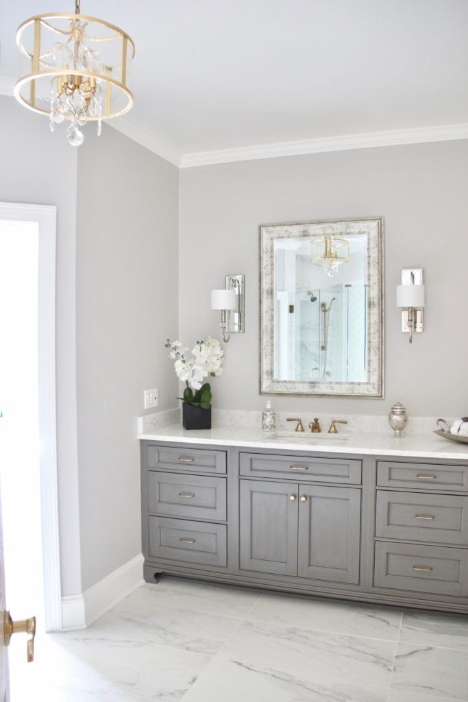 a bathroom with two sinks and a large mirror on the wall over it's vanity