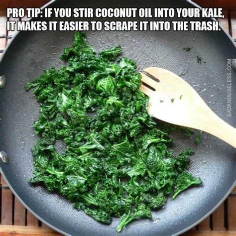 a frying pan filled with greens and a wooden spoon