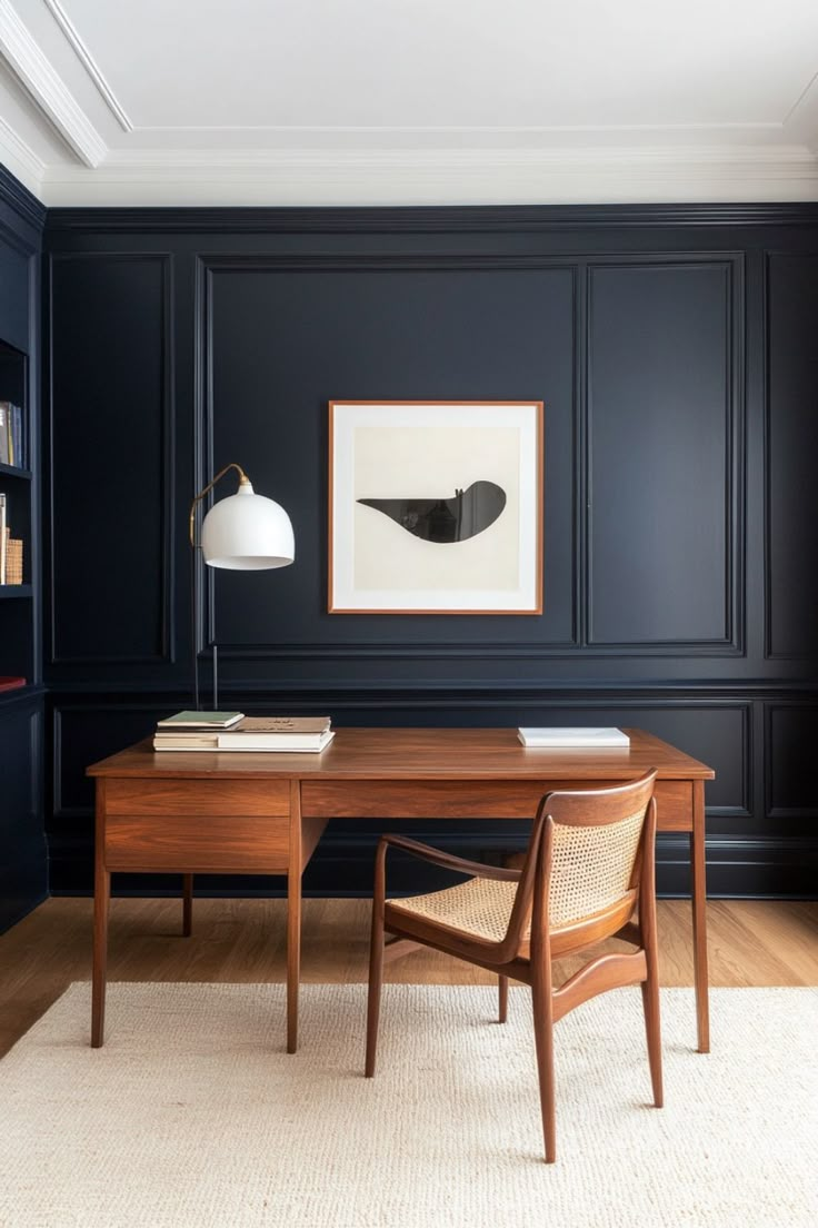 an office with dark blue walls and wooden furniture, including a large painting on the wall