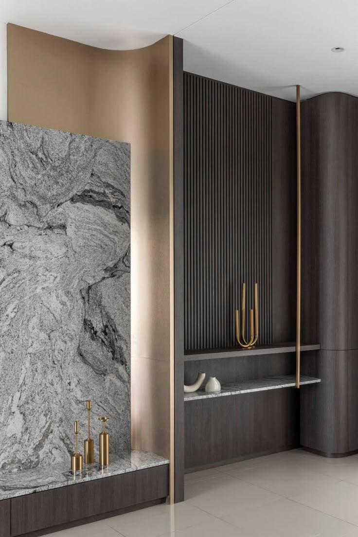 an elegant bathroom with marble walls and flooring, along with gold accents on the wall