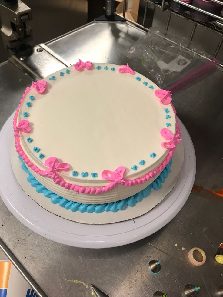 a white cake with pink and blue frosting