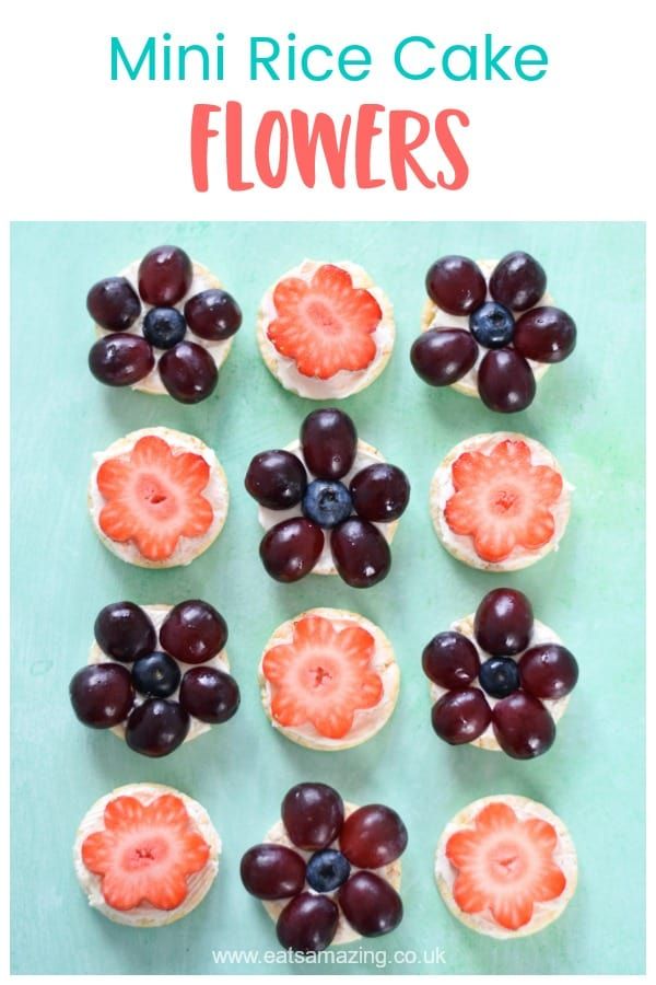 mini rice cake flowers with grapes and strawberries in them on a blue background, text overlay reads mini rice cake flowers