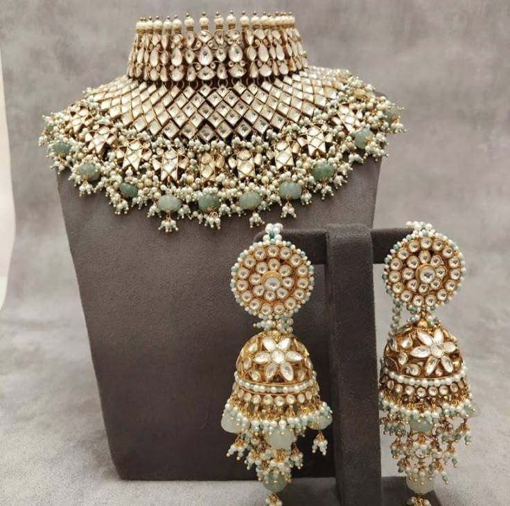 an elaborate necklace and earring set on display