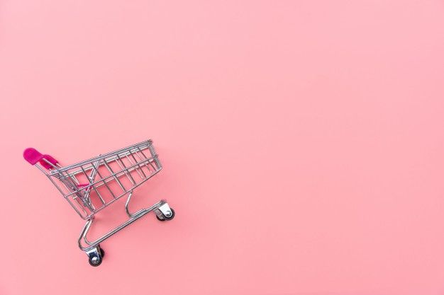 a small shopping cart on a pink background