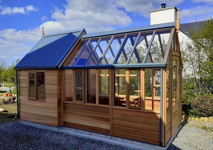 a small wooden house with a blue roof